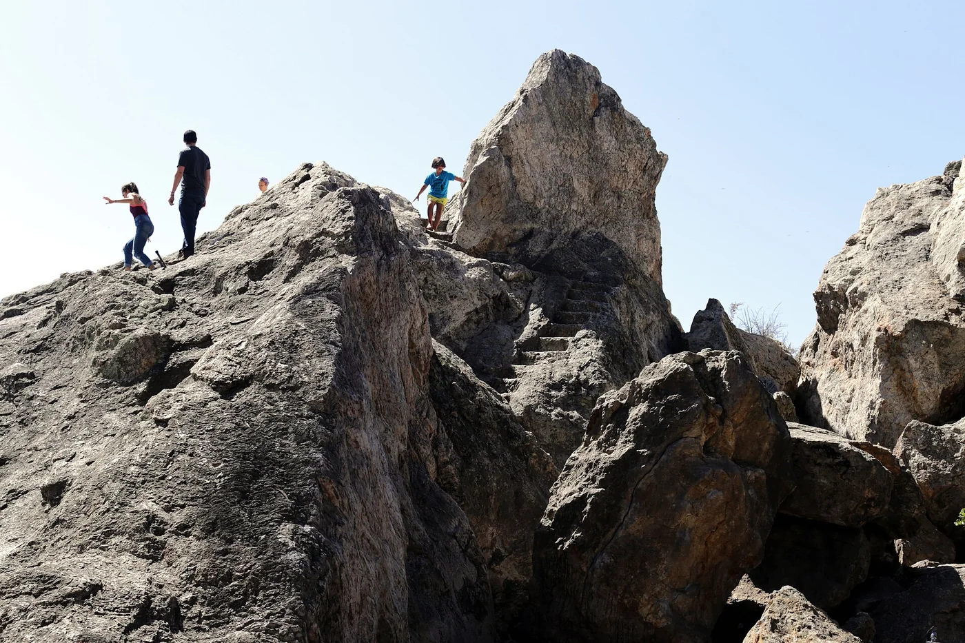Visitors standing on the rocky summit at Indian Rock Park in the Berkeley Hills